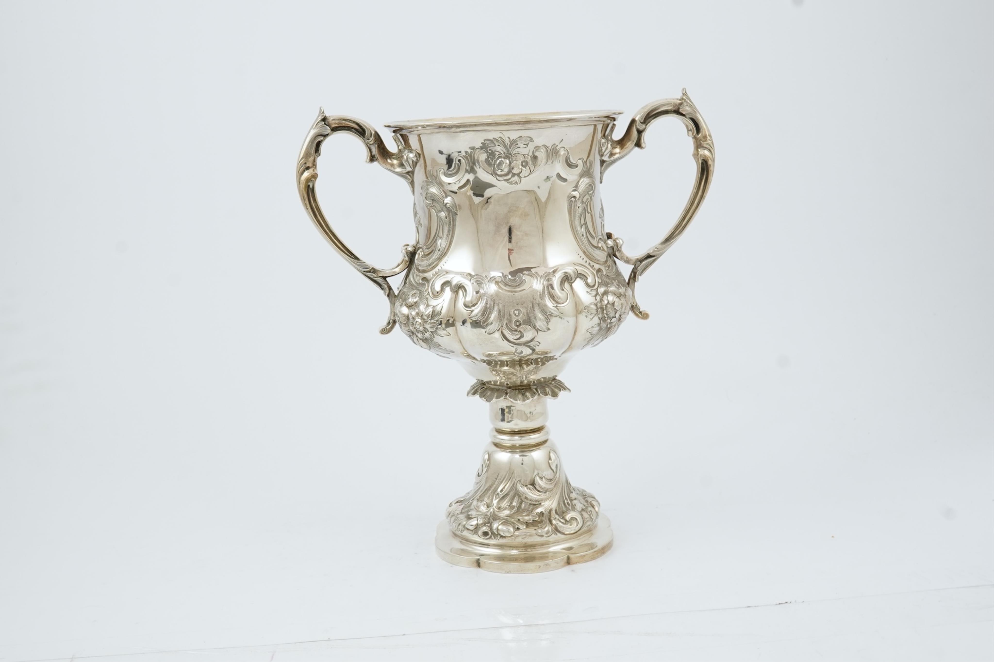 A Victorian embossed silver two handled presentation trophy cup by George John Richards & Edward Charles Brown